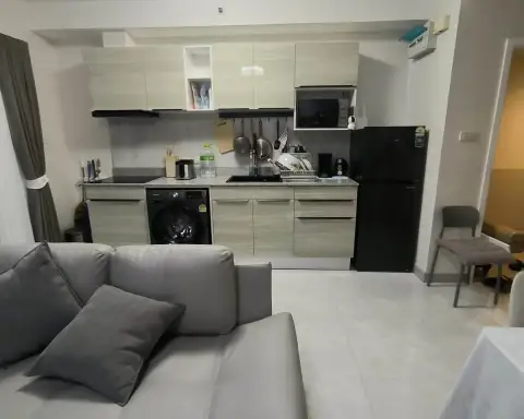 2 Bedroom Condo for Rent at Supalai Mare Pattaya kitchenette with washing machine, fridge, and cookware