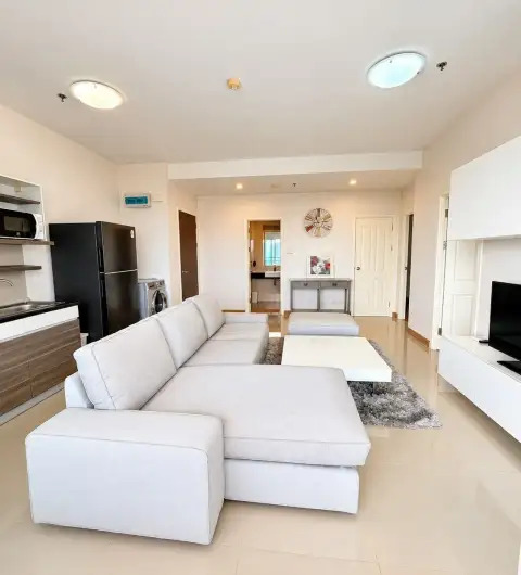 2 Bedroom Condo for Sale at Supalai Mare Pattaya spacious living room with sectional sofa and kitchenette