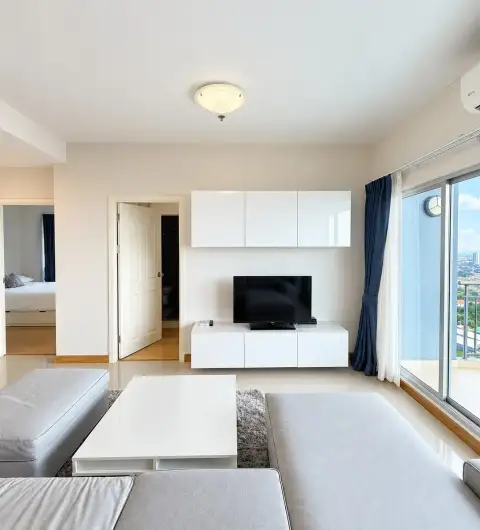 2 Bedroom Condo for Sale at Supalai Mare Pattaya living room with TV unit and balcony access
