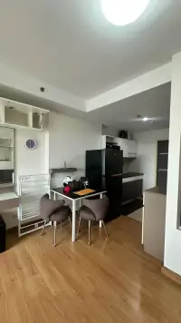 Studio Condo for Rent at Supalai Mare Pattaya dining nook with small table, chairs and kitchen view