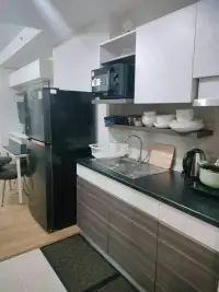Studio Condo for Rent at Supalai Mare Pattaya kitchen with fridge, microwave and dish rack