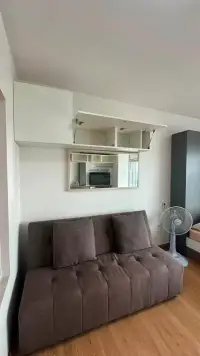 Studio Condo for Rent at Supalai Mare Pattaya sofa seating area with overhead storage and mirror