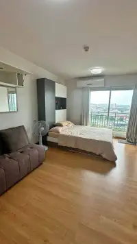 Studio Condo for Rent at Supalai Mare Pattaya bedroom with city view balcony and wooden flooring