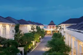 Tadarawadi South Pattaya aerial view of multiple houses with dark roofs, a central driveway, and green trees.