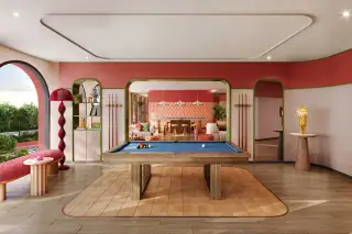 D Condo Vite colorful game room featuring a pool billiards table, lounge seating, and vibrant retro-style interior decor