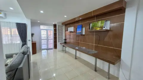 3 Bedroom House for Rent at T.W. Palm Resort hallway with wooden display shelving and tiled flooring
