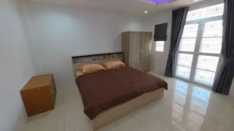 3 Bedroom House for Rent at T.W. Palm Resort bedroom with double bed, wardrobe and curtained window