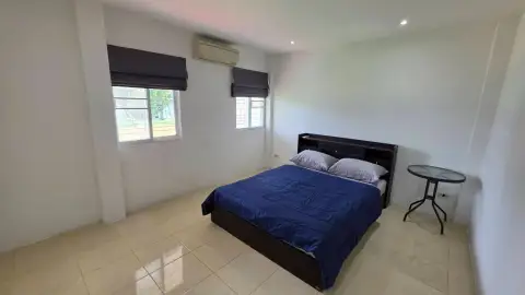 3 Bedroom House for Rent at T.W. Palm Resort bedroom with blue bedding and natural light windows