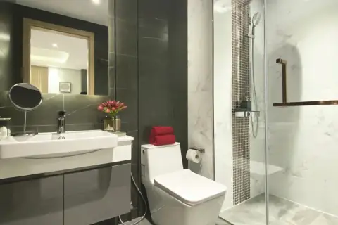 1 Bedroom Condo for Sale at Pristine Park 3 modern bathroom with glass shower, marble tiles and vanity sink
