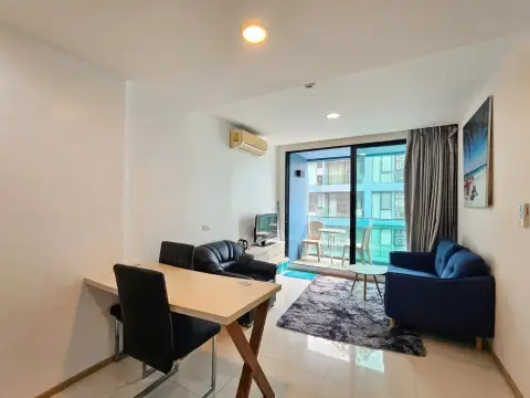 1 Bedroom Condo for Sale at Acqua Condo living area with sofas, dining table, and balcony view