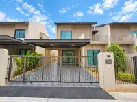 4 Bedroom House for Rent in Takhian Tia two-story home exterior with gated driveway and carport