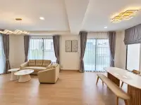 4 Bedroom House for Rent in Takhian Tia bright living and dining area with wood flooring and large windows