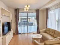 4 Bedroom House for Rent in Takhian Tia living room with leather sofas, TV unit, and sliding glass door
