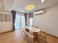 4 Bedroom House for Rent in Takhian Tia dining area with wooden table, bench seating, and air conditioner