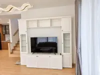 4 Bedroom House for Rent in Takhian Tia entertainment unit with flat-screen TV and staircase view