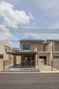 4 Bedroom House for Rent in Takhian Tia two-story exterior with carport and gated entrance