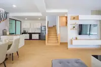 4 Bedroom House for Rent in Takhian Tia kitchen, staircase, and living room with wall-mounted TV