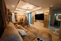 4 Bedroom House for Rent in Takhian Tia cozy living room with wall-mounted TV and display cabinets