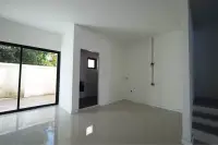 4 Bedroom Townhouse for Sale in Takhian Tia unfinished room with glass door, hallway entrance, and staircase edge visible