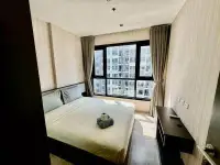 1 Bedroom Condo for Sale at The Base Central Pattaya bedroom with city view window and neatly made bed