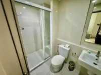 1 Bedroom Condo for Sale at The Base Central Pattaya bathroom with glass shower stall and toilet