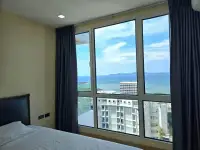 1 Bedroom Condo for Sale at The Cliff floor-to-ceiling bedroom window showing ocean and city skyline