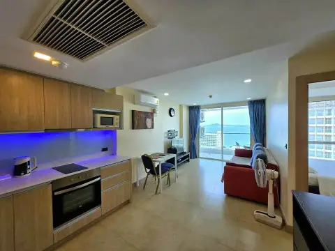 1 Bedroom Condo for Sale at The Cliff open-plan kitchen and living area with wooden cabinets and sea view