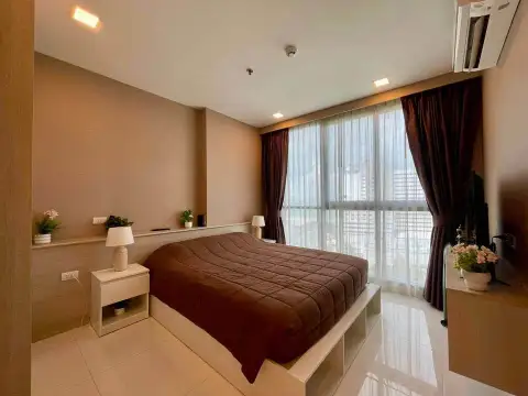 1 Bedroom Condo for Sale at The Cloud bedroom with brown bedding, nightstands and floor-to-ceiling windows