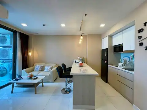 1 Bedroom Condo for Sale at The Cloud living area with bar stools, kitchen and balcony door
