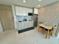2 Bedroom Condo for Sale at The Cloud modern white kitchen with dining area and front entrance door