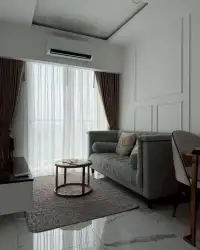1 Bedroom Condo for Rent at The Empire Tower Pattaya tufted gray sofa with patterned cushions against paneled wall