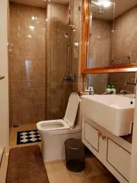 1 Bedroom Condo for Rent at The Empire Tower Pattaya bathroom with glass shower, white toilet and vanity sink