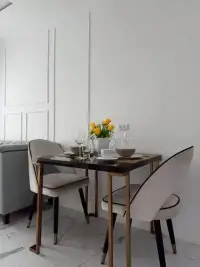 1 Bedroom Condo for Rent at The Empire Tower Pattaya dining area with marble table set for two and fresh flowers