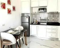 1 Bedroom Condo for Rent at The Empire Tower Pattaya kitchen and dining area with marble table and fridge