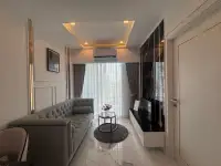 1 Bedroom Condo for Sale at The Empire Tower Pattaya living room with tufted gray sofa and marble flooring