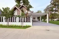 3 Bedroom House for Sale at The Flow Pong - Mabprachan modern facade with covered carport, paved driveway and decorative fence