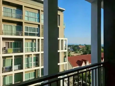 1 Bedroom Condo for Rent at The Gallery Condominium balcony overlooking neighboring buildings and distant sea