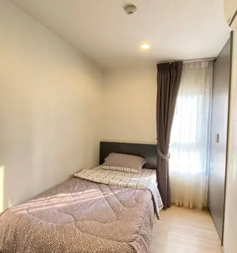 2 Bedroom Condo for Rent at The Grass bedroom with single bed, curtains, and built-in wardrobe