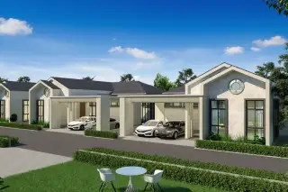 The Hamlet Pattaya, exterior view of modern houses with carports, green lawns, and a street under a blue sky.