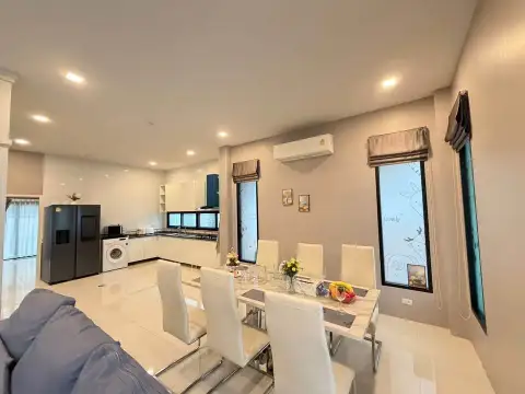 3 Bedroom House for Rent at The Lake Huay Yai dining area with white table and open kitchen view