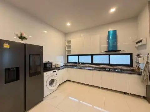 3 Bedroom House for Rent at The Lake Huay Yai modern kitchen with black countertops and stainless appliances