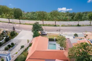 The Lakes Pool Villa aerial view showing red-tiled roofs, a private swimming pool, and surrounding roads with lush greenery.