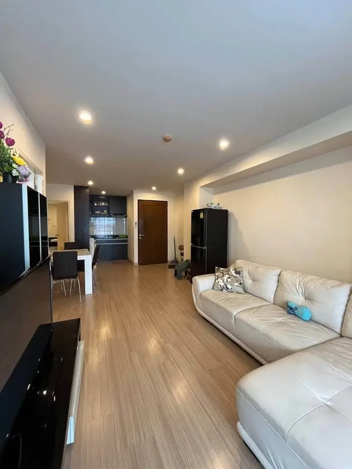 2 Bedroom Condo for Sale at The Ocean Pearl living room with white leather sofa and open dining area