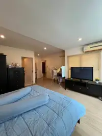 2 Bedroom Condo for Sale at The Ocean Pearl master bedroom with black dresser, TV unit, and air conditioner