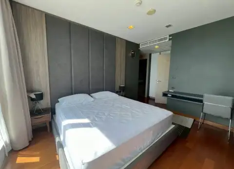 2 Bedroom Condo for Rent at Palm Wongamat bedroom with upholstered headboard and wooden flooring