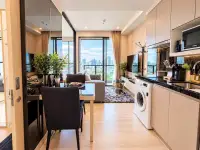 1 Bedroom Condo for Rent at The Panora Pattaya kitchen and dining area with city skyline view through balcony windows