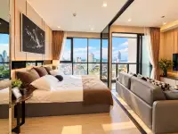 1 Bedroom Condo for Rent at The Panora Pattaya bedroom with king bed, sofa seating, and panoramic city view