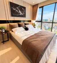 1 Bedroom Condo for Rent at The Panora Pattaya king-size bed with star artwork and floor-to-ceiling city view windows