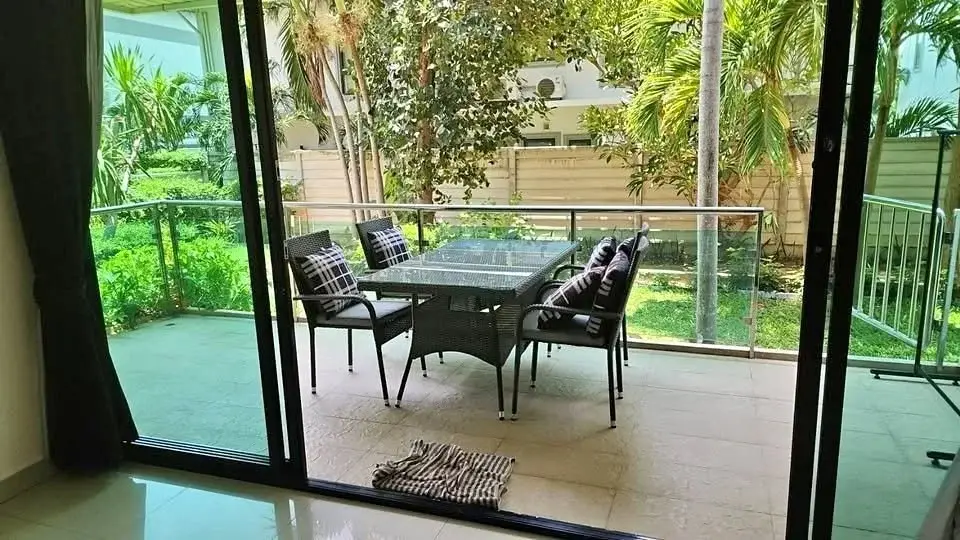 2 Bedroom Condo for Sale at The Park Jomtien balcony with rattan dining set and garden view