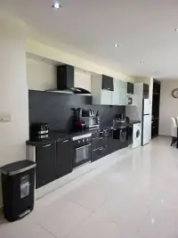 2 Bedroom Condo for Sale at The Park Jomtien modern black kitchen with built-in oven and appliances